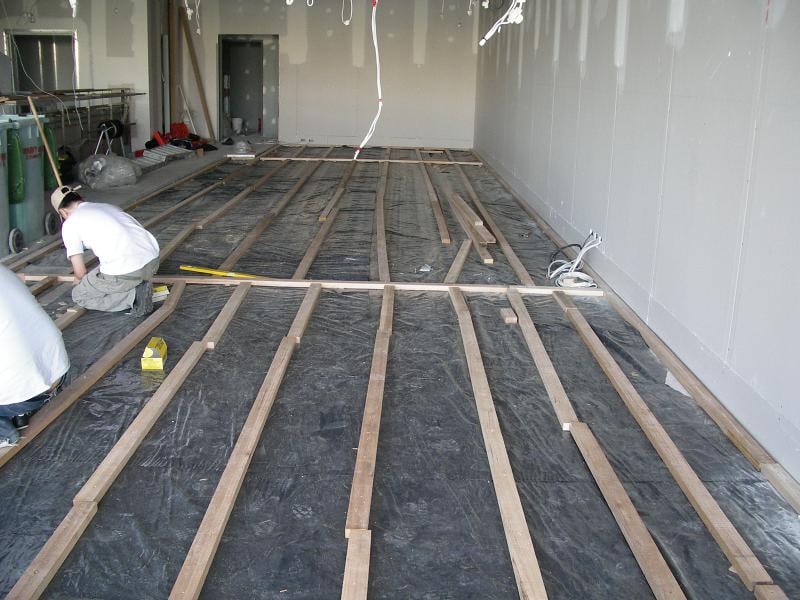 Crew preparing timber battens for a new floor installation