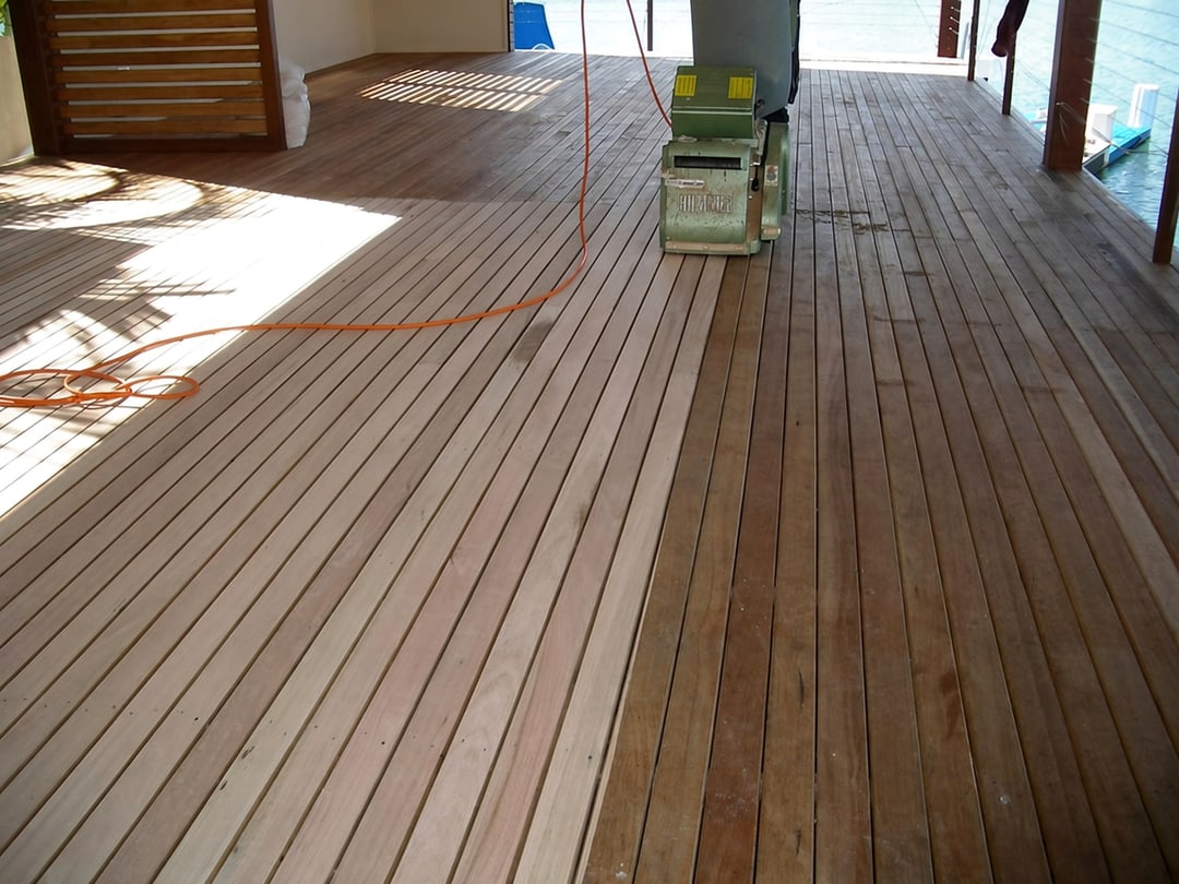 Drum sander restoring weathered outdoor timber decking