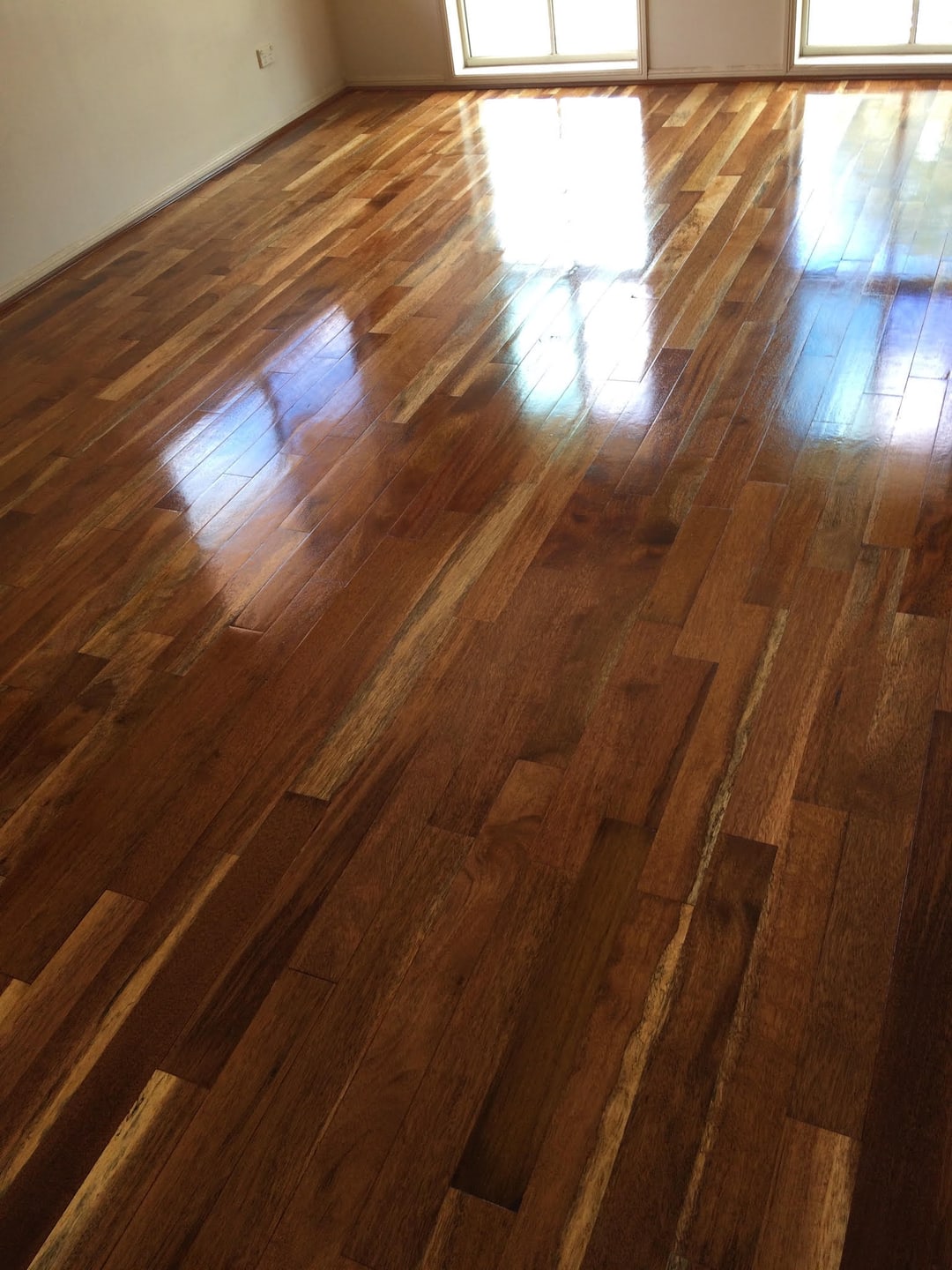 High-gloss timber floor after sanding and polishing