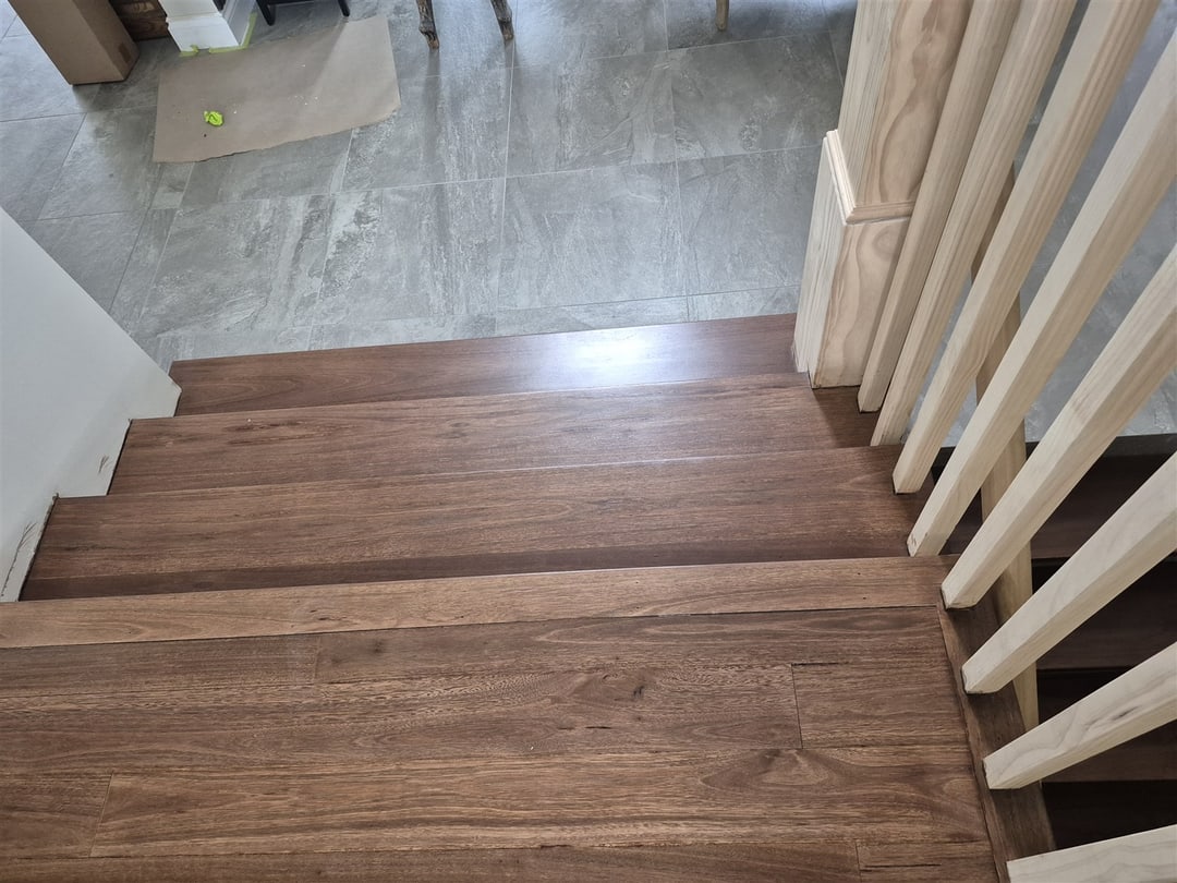 Wide dark-stained landing tread beside the balustrade, Brisbane