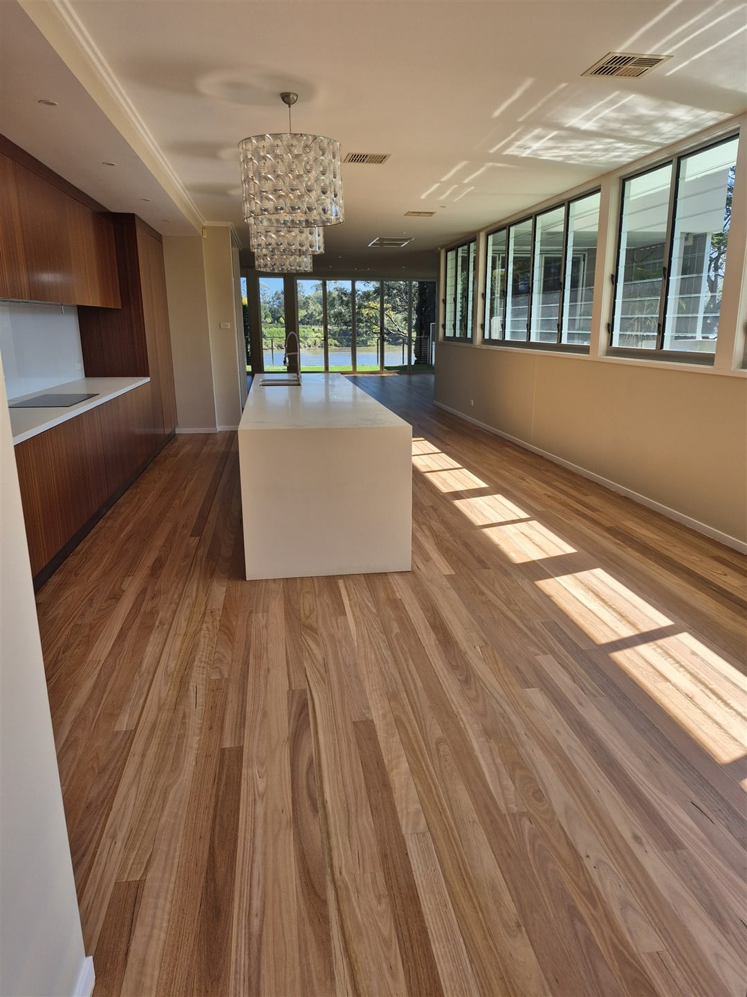 Open-plan kitchen and window wall on blackbutt, Brisbane