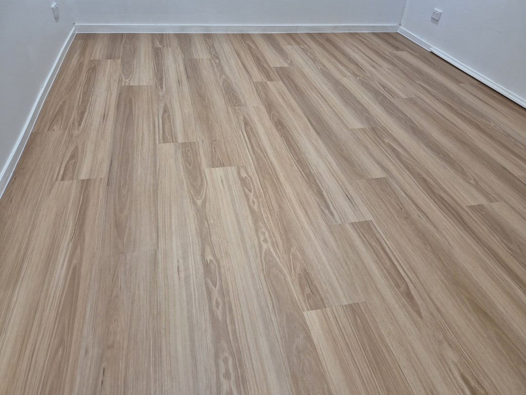 Blackbutt-look vinyl planks across an empty bedroom, Brisbane