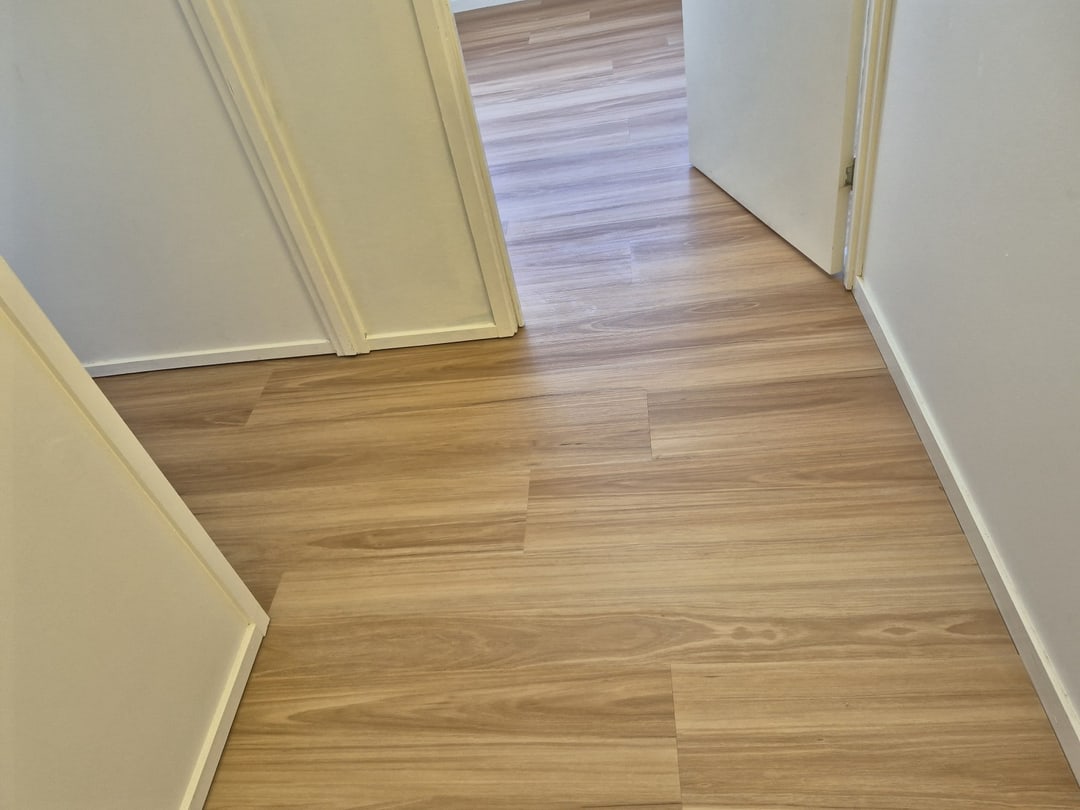 Vinyl planks continuing through a doorway into the hall, Brisbane