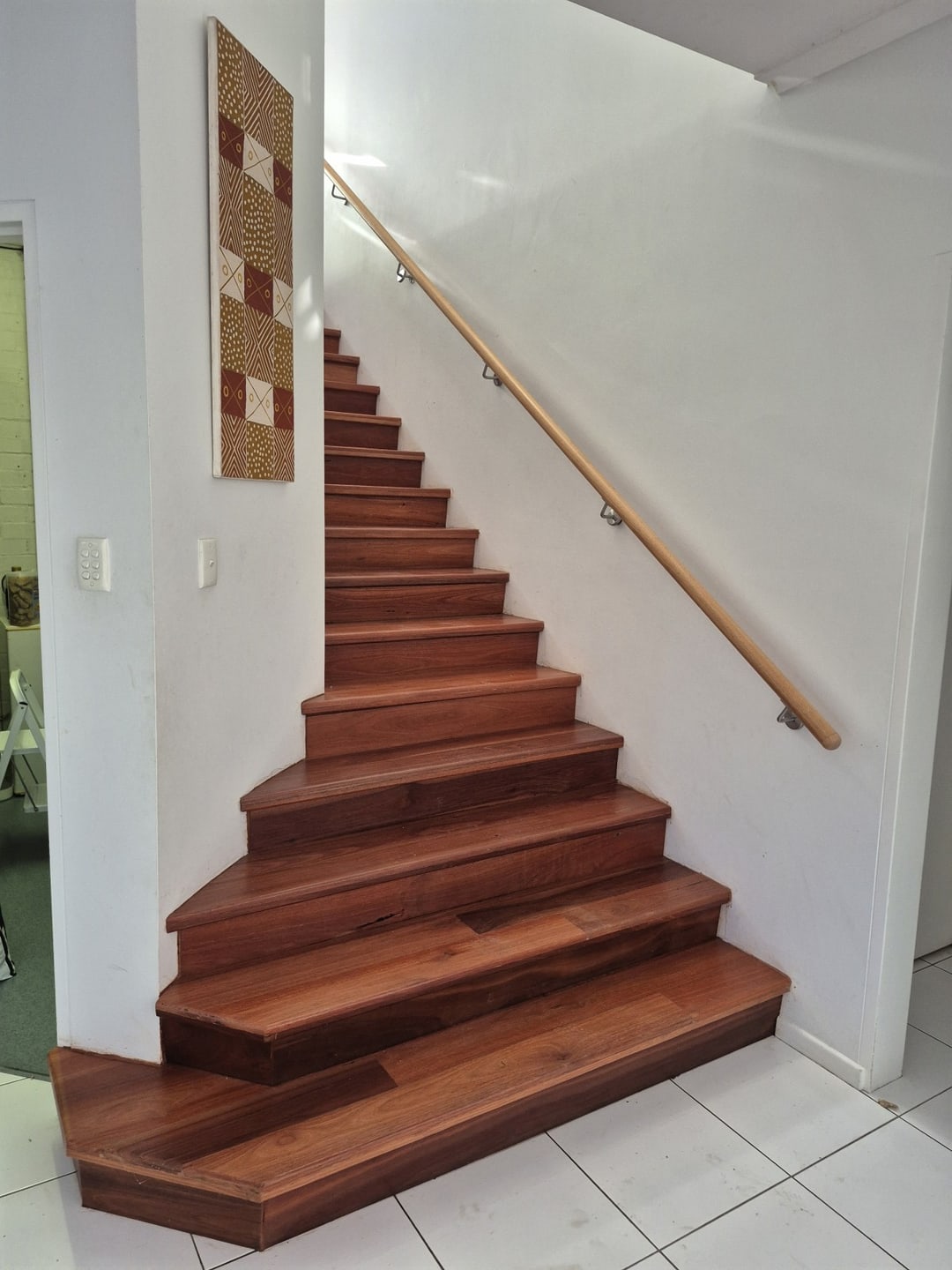Jarrah staircase with angled bottom steps onto tiles, Brisbane