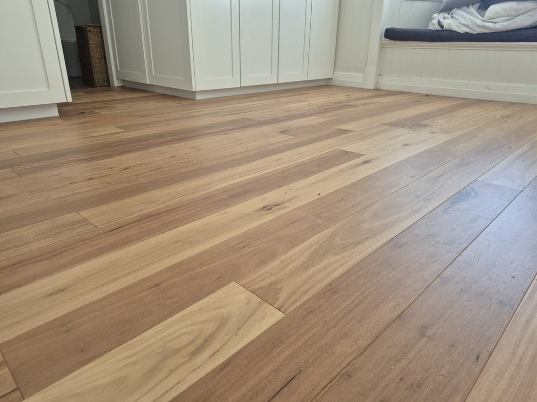 Blackbutt floor in a bedroom with built-in wardrobes and window seat, Sandgate, Brisbane